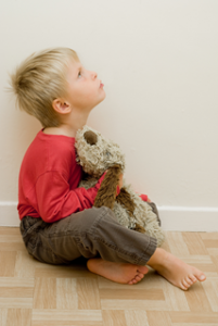 a little boy holding a stuffed bear