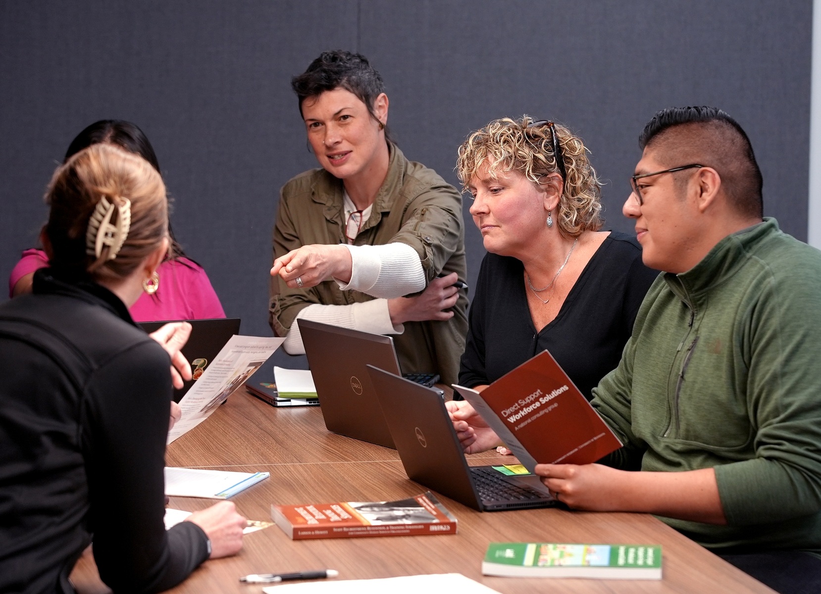 The Direct Support Workforce Solutions staff in a meeting.