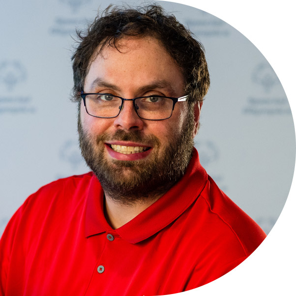 Man with glasses and beard wearing red shirt