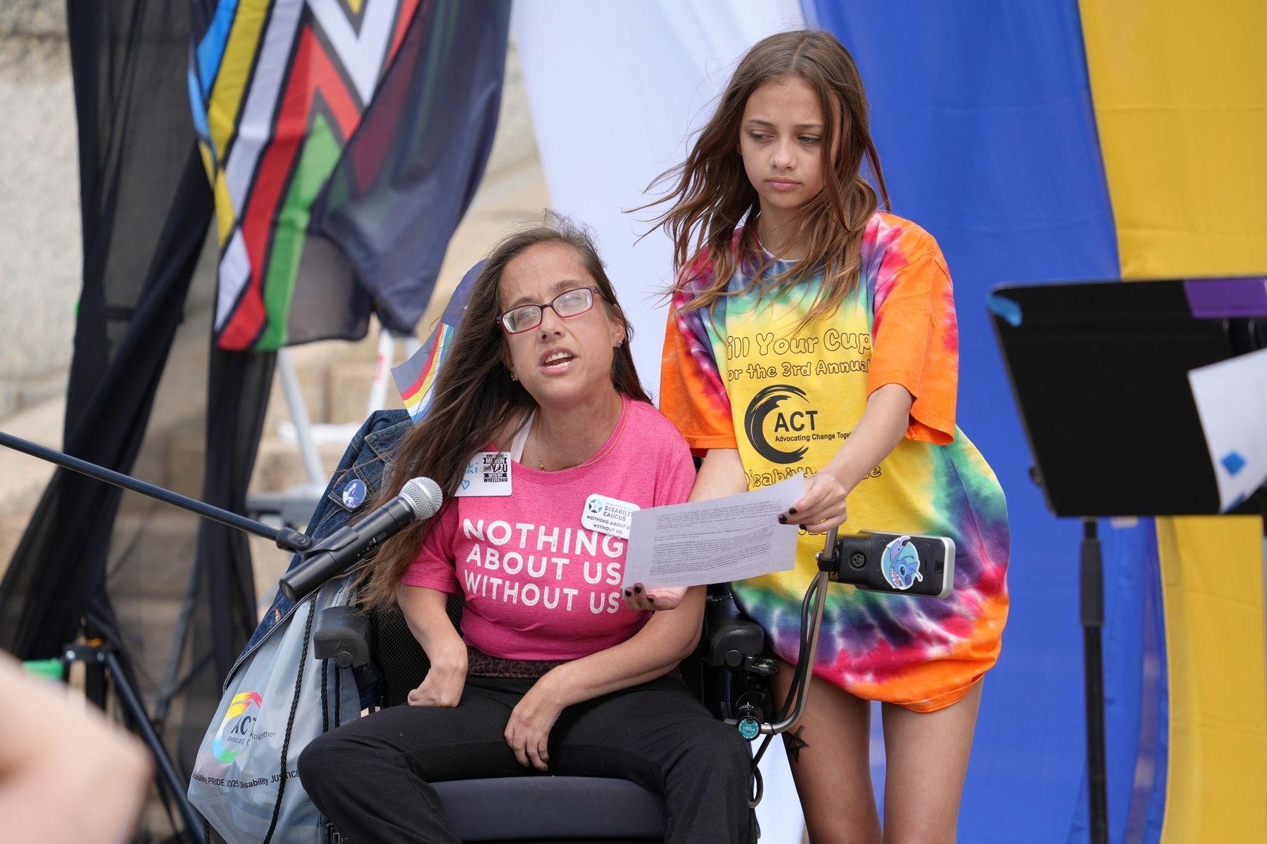 Nikki Villavicencio (seated in wheelchair) speaks to the crowd at the Disability Pride Festival in July 2025.