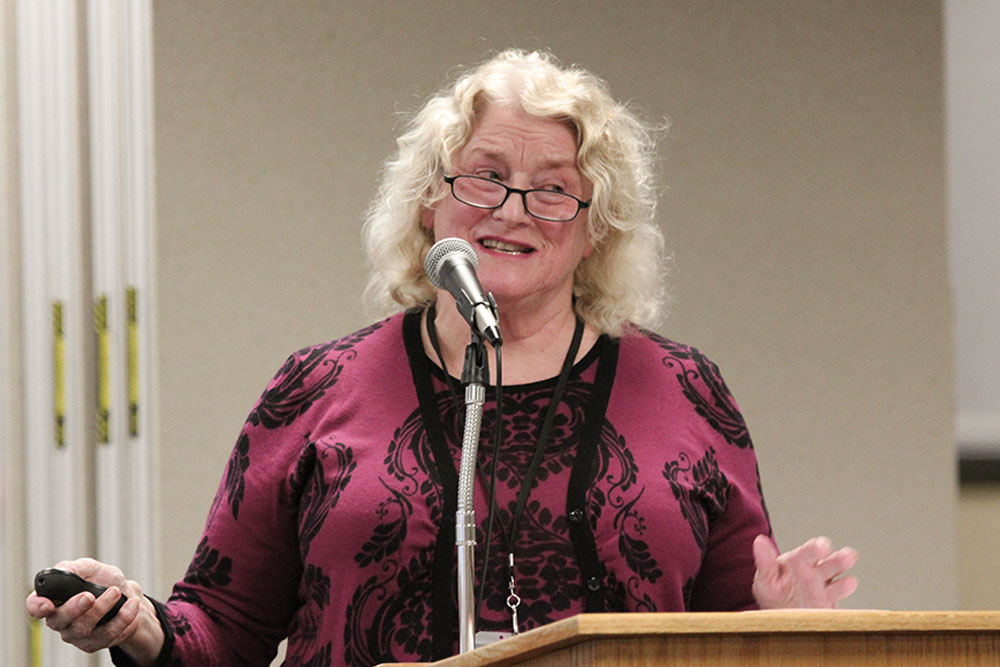 Norena Hale speaks at a lectern.