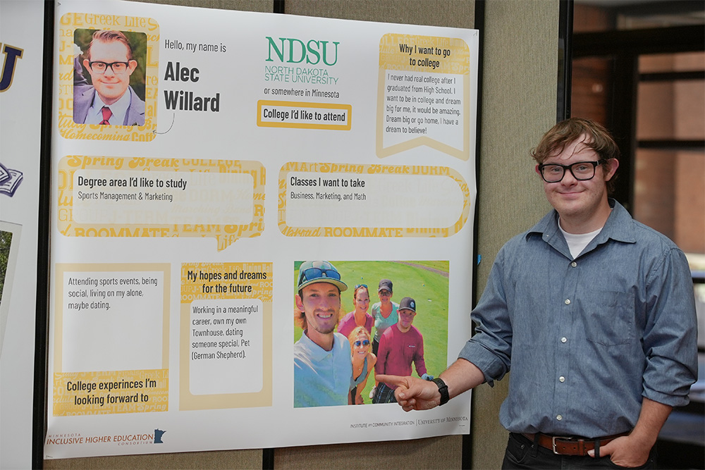 Alec Willard presents his poster at a conference.