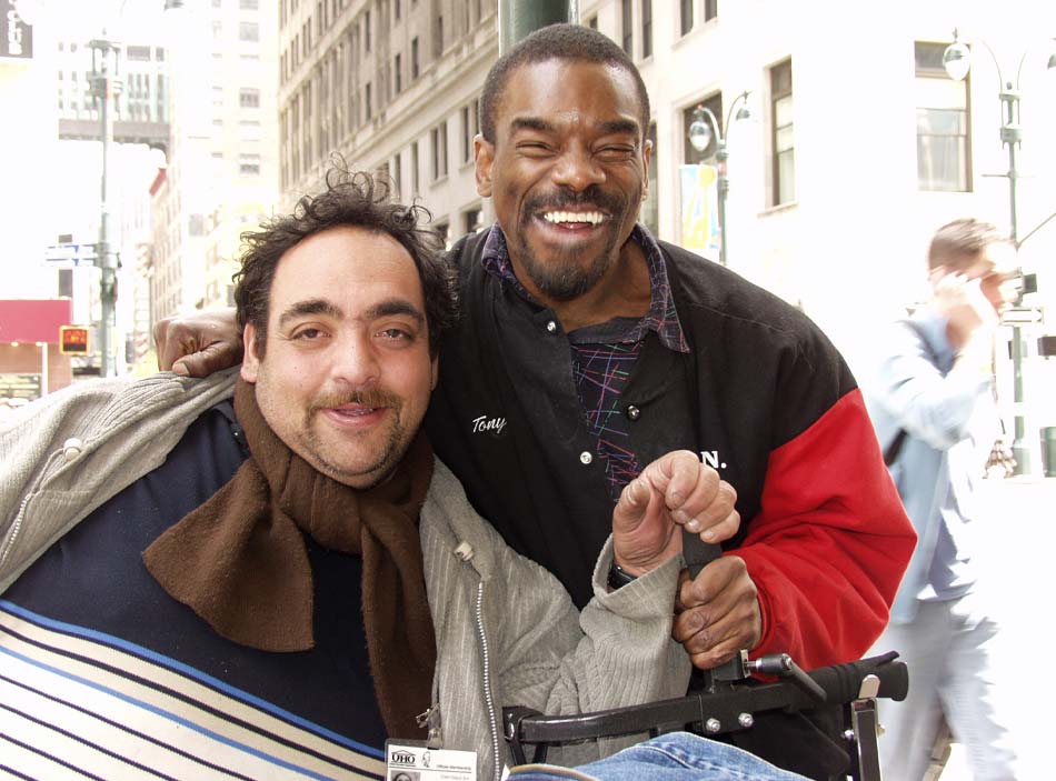 Two men smile straight at the camera.