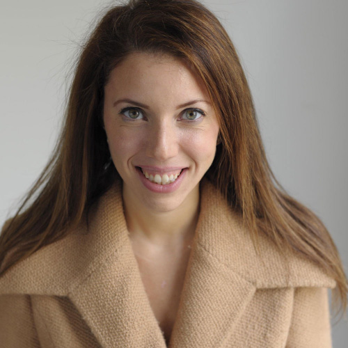 woman reddish long straight hair, light brown coat