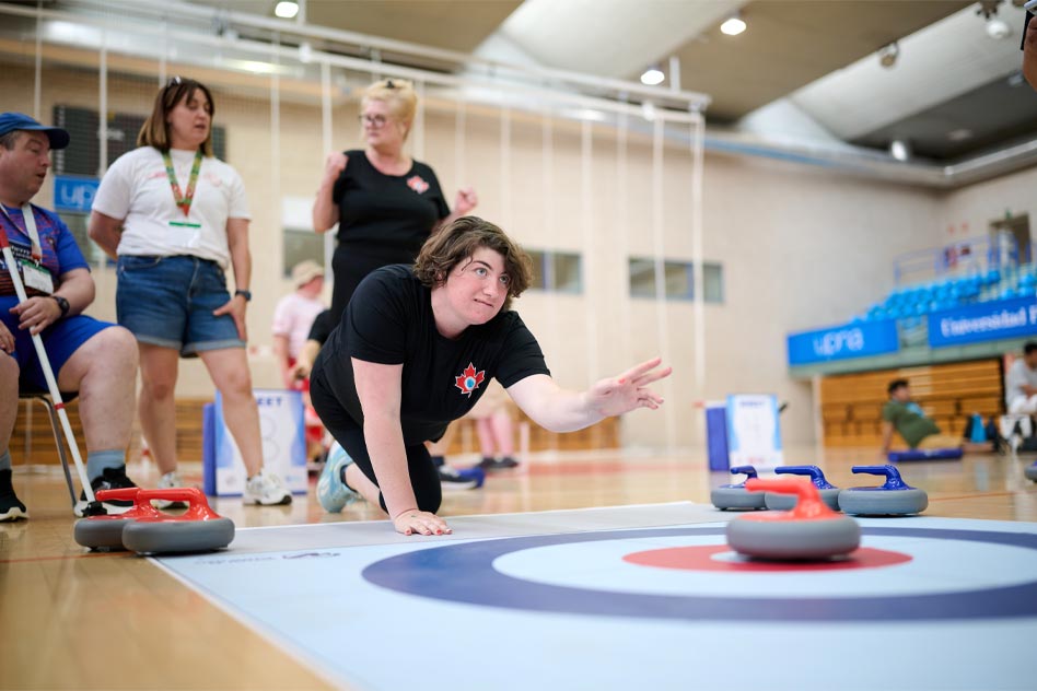 a person crouched down during a floor curling event