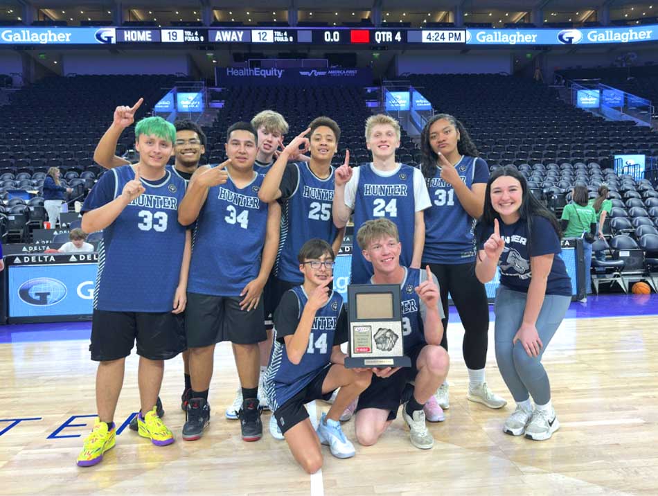 basketball team posing on the court